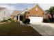 Traditional brick home with a two-car garage, manicured lawn, and tasteful landscaping at 52538 Winchester St, Fort Mill, SC 29707