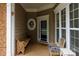 Cozy front porch with seating, neutral color scheme, and inviting entrance at 52538 Winchester St, Fort Mill, SC 29707