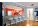 Bright kitchen featuring granite countertops, modern stools at the bar, and an open view to the dining area at 52538 Winchester St, Fort Mill, SC 29707