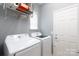 Well-lit laundry room with modern washer and dryer and ample storage space at 52538 Winchester St, Fort Mill, SC 29707