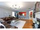 Open living room boasts hardwood floors, stylish lighting, and seamless access to the kitchen at 52538 Winchester St, Fort Mill, SC 29707