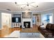 This spacious living room includes a fireplace, a modern light fixture, and a seamless connection to the other rooms at 52538 Winchester St, Fort Mill, SC 29707