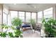 Relaxing sunroom featuring large windows, wicker furniture, and abundant greenery, perfect for enjoying natural light at 52538 Winchester St, Fort Mill, SC 29707