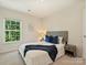 Bright bedroom featuring a large window and a comfortable bed with blue accents at 6037 Guildford Hill Ln, Charlotte, NC 28215