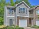 Charming townhome featuring stone accents and an attached one car garage at 6037 Guildford Hill Ln, Charlotte, NC 28215