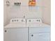 Laundry room with white washer and dryer and wire rack for storage at 6037 Guildford Hill Ln, Charlotte, NC 28215