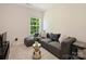 Cozy living room with modern sofa, accent pillows, and decorative plant at 6037 Guildford Hill Ln, Charlotte, NC 28215