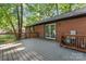 Spacious outdoor deck made of composite boards with a brick house facade in background at 606 Deer Creek Dr, Matthews, NC 28105