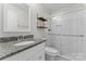 Modern bathroom with granite vanity and updated shower featuring a sliding glass door at 606 Deer Creek Dr, Matthews, NC 28105