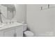 Well-lit bathroom features a shower, toilet, and vanity with storage at 606 Deer Creek Dr, Matthews, NC 28105