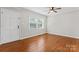 Bedroom featuring neutral paint, window with blinds, ceiling fan and hardwood flooring at 606 Deer Creek Dr, Matthews, NC 28105