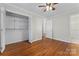 This bedroom features hardwood floors, a large closet, and convenient access to the bathroom at 606 Deer Creek Dr, Matthews, NC 28105