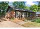 This charming brick home boasts a spacious driveway and well-manicured landscaping at 606 Deer Creek Dr, Matthews, NC 28105