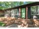 Charming brick home featuring a green front door with black shutters and a cozy front porch at 606 Deer Creek Dr, Matthews, NC 28105