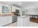 Kitchen featuring stainless appliances, island with granite counters and sink with window at 606 Deer Creek Dr, Matthews, NC 28105