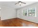 A bright and airy living room features beautiful hardwood floors and a ceiling fan at 606 Deer Creek Dr, Matthews, NC 28105