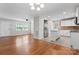 Bright, open-concept living room with hardwood floors seamlessly connects to the updated kitchen at 606 Deer Creek Dr, Matthews, NC 28105