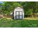A charming storage shed in the backyard provides ample space for gardening tools and outdoor equipment at 606 Deer Creek Dr, Matthews, NC 28105