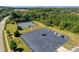 Aerial view of the community tennis courts, parking area, and surrounding wooded area at 6176 Russo Ct, Lancaster, SC 29720