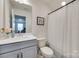 This full bathroom features a grey vanity with white countertops and a shower with tub at 6176 Russo Ct, Lancaster, SC 29720