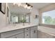 Bright bathroom featuring double vanity sinks, a soaking tub, and a glass-enclosed shower at 6176 Russo Ct, Lancaster, SC 29720
