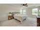 Spacious bedroom featuring a tray ceiling, ceiling fan, and plentiful natural light from the windows at 6176 Russo Ct, Lancaster, SC 29720