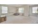 Spacious bonus room bathed in natural light, perfect for play or relaxation, with plush carpet and ample space at 6176 Russo Ct, Lancaster, SC 29720