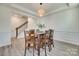 Dining room features wood floors, crown molding, and a stylish light fixture above the table at 6176 Russo Ct, Lancaster, SC 29720