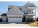 Beautiful two-story home with light gray siding, a two-car garage, and a covered porch at 6176 Russo Ct, Lancaster, SC 29720