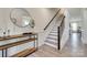 Foyer featuring wood floors, stairs, console table with a round mirror, and white trim at 6176 Russo Ct, Lancaster, SC 29720