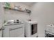 Laundry room boasts Samsung washer and dryer, wire shelving, and a modern organizer at 6176 Russo Ct, Lancaster, SC 29720