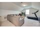 Cozy living room with neutral walls and carpet flooring and a comfortable grey sectional at 6176 Russo Ct, Lancaster, SC 29720