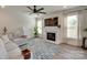 Cozy living room with fireplace, large TV, neutral walls, and lots of natural light from the large windows at 6176 Russo Ct, Lancaster, SC 29720