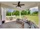 Enjoy an outdoor covered patio with seating, ceiling fan, and views of the backyard at 6176 Russo Ct, Lancaster, SC 29720