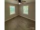 Well-lit bedroom with dual windows, ceiling fan, and wood-look flooring at 654 Old Nc 515 Hwy, Wadesboro, NC 28170