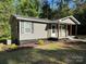 Side view of a charming gray home featuring landscaping and lush green grass at 654 Old Nc 515 Hwy, Wadesboro, NC 28170