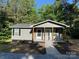 Charming gray house with wood posts supporting a porch and lush landscaping at 654 Old Nc 515 Hwy, Wadesboro, NC 28170