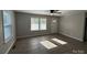 Bright living room with wood-look floors, ceiling fan and many windows at 654 Old Nc 515 Hwy, Wadesboro, NC 28170