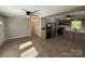 Open-concept living room and kitchen featuring stainless steel appliances and updated flooring at 654 Old Nc 515 Hwy, Wadesboro, NC 28170