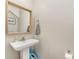 Charming powder room features a pedestal sink, framed mirror, and neutral decor at 658 Morgan Rd, Albemarle, NC 28001