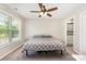Comfortable bedroom with a ceiling fan, a large window, and ensuite bathroom at 658 Morgan Rd, Albemarle, NC 28001