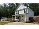 Charming two-story home featuring a cozy front porch with rocking chairs and manicured landscaping at 658 Morgan Rd, Albemarle, NC 28001