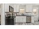 Well-lit kitchen features stainless steel appliances, granite countertops, and white cabinetry at 658 Morgan Rd, Albemarle, NC 28001