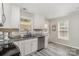Bright kitchen featuring stainless steel appliances, white cabinets, and granite countertops at 658 Morgan Rd, Albemarle, NC 28001