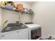 Modern laundry room with shelving, washer, and dryer for convenience at 658 Morgan Rd, Albemarle, NC 28001