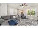 Cozy living room with a plush sofa, recliner, and stylish rug, complete with a ceiling fan at 658 Morgan Rd, Albemarle, NC 28001