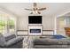 Comfortable living room featuring a fireplace, TV, and ample seating with grey couches at 658 Morgan Rd, Albemarle, NC 28001