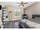 Bedroom with hardwood floors, large window, ceiling fan, and custom shelves at 6912 Park Place Dr, Charlotte, NC 28262