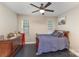 A bedroom with neutral walls features hardwood floors and large sunny windows at 6912 Park Place Dr, Charlotte, NC 28262