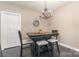 Dining room with modern chandelier, table with chairs and dark wood floor at 6912 Park Place Dr, Charlotte, NC 28262